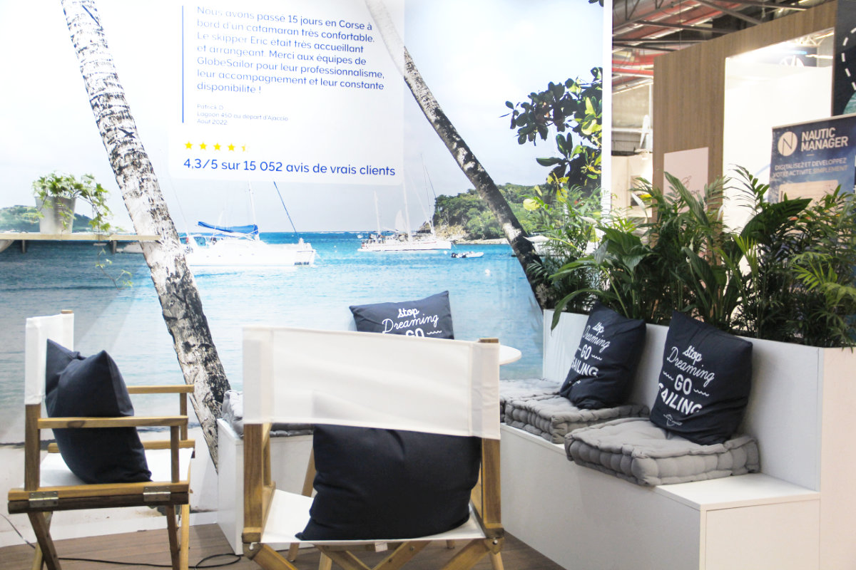 Right corner of the GlobeSailor stand. There are chairs and a bench with cushions.